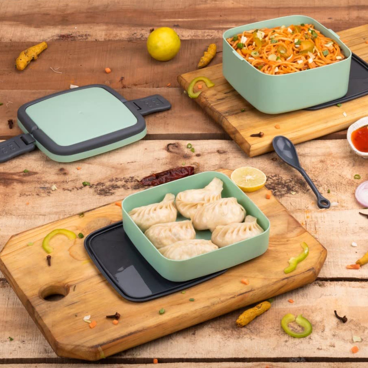 Green lunch box with handle and spoon for easy carrying Green lunch box with handle and spoon for easy carrying